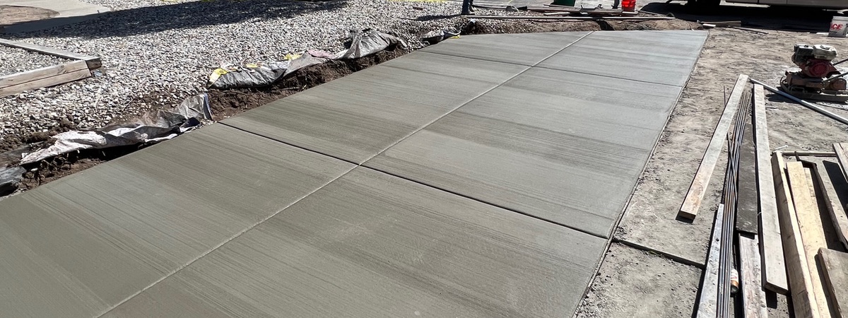 Wide new concrete driveway poured to the street with forms still in place