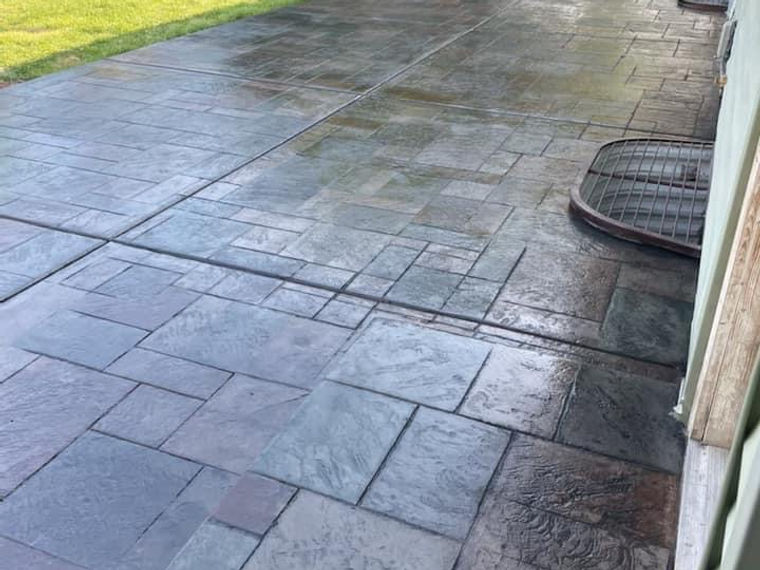 Stamped concrete patio in an ashlar slate pattern with warm colour